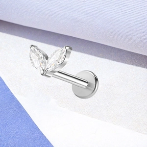 Macro view of marquise cut zircon inlay on polished silver titanium labret piercing stud
