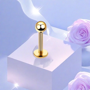 Macro shot of polished gold titanium flat back stud earring on a lavender pedestal