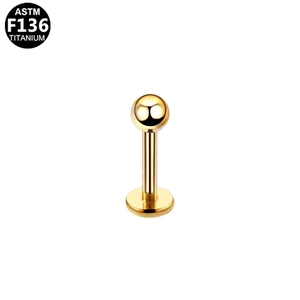 Macro detail of gold ASTM F136 titanium labret stud with ball top and flat back base