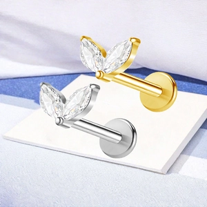 Close-up of F136 titanium marquise zircon leaf earrings in silver and gold finish