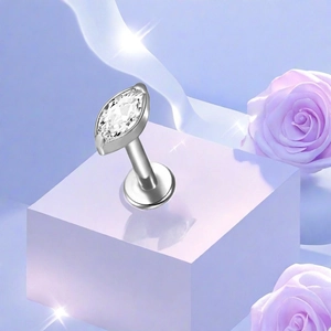 Macro detail of F136 titanium marquise zircon labret stud on a purple floral display