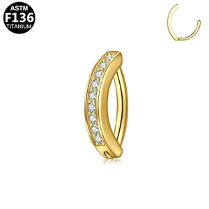 Detail eines Bauchnabelpiercings aus ASTM F136 Titan in Gold mit Zirkon-Steinen