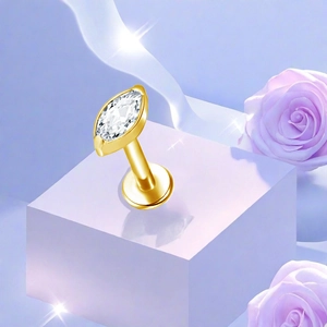 Detailed view of marquise-cut zircon labret stud in golden titanium on a floral display