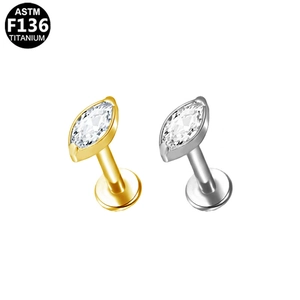 Detailed macro view of ASTM F136 titanium marquise stud earrings in gold and silver finish