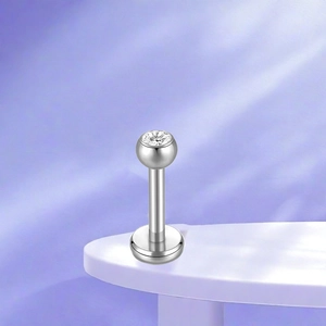 Detailed macro view of silver F136 titanium labret stud with a sparkling round zircon