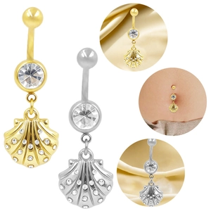 Macro view of shell-shaped belly ring with sparkling zircon and detailed metal texture