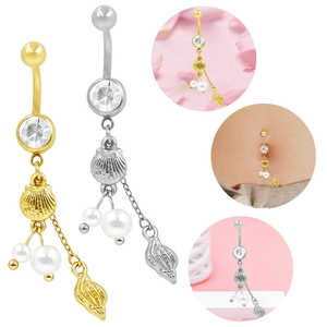 Dettaglio di piercing all'ombelico con conchiglie e perle in finitura oro e argento