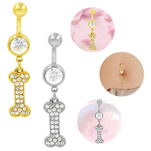 Dettaglio macro di piercing all'ombelico a forma di osso in oro e argento con zirconi