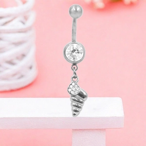 Detail of a stainless steel belly ring featuring a large zircon and conch shell pendant