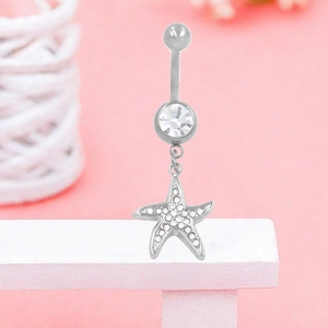 Macro detail of silver starfish belly ring with sparkling cubic zirconia and pavé stones