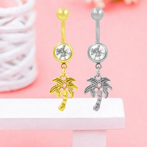 Macro detail of coconut tree belly rings with round cubic zirconia in gold and silver finish