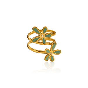 Detail of gold spiral ring featuring green enamel flowers and crystal accents