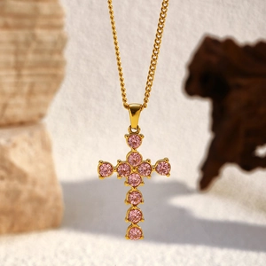 Gold stainless steel cross necklace featuring 11 sparkling pink round crystal pendants