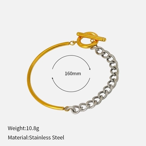 Bracelet bicolore en acier inoxydable avec barre dorée et chaîne cubaine argentée à fermoir