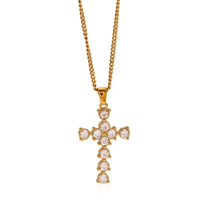 Polished gold stainless steel cross necklace with shimmering zircon stones on white background