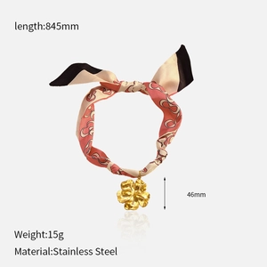 Detail of printed silk scarf necklace with 46mm gold stainless steel flower pendant