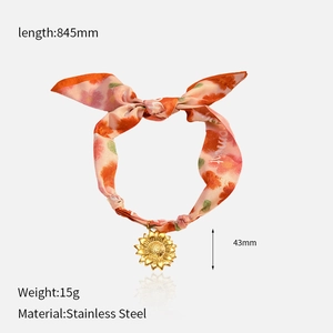 Detail of floral scarf necklace with premium stainless steel sunflower pendant