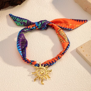 Elegant ocean-style scarf choker necklace with a gold sun pendant and colorful printed ribbon