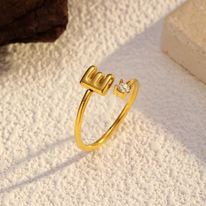 Détail de la bague plaquée or 18k avec la lettre E et une pierre en zircone scintillante