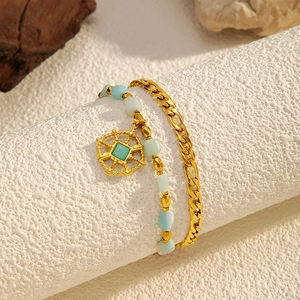 Double-layered gold chain bracelet with natural turquoise beads and octagonal star pendant