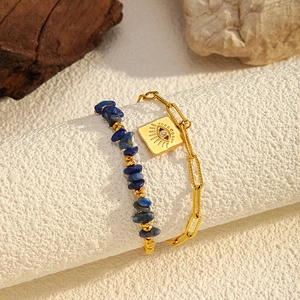 Detail of double-layer bracelet featuring natural blue stones and evil eye charm