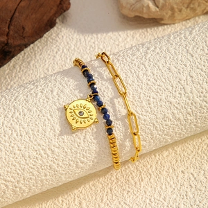 Double-layer gold bracelet with blue beads and evil eye pendant in Bohemian style