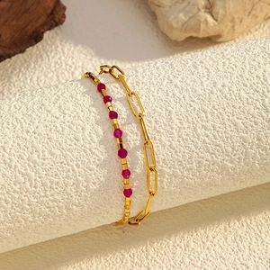 Double-layered golden paperclip chain bracelet with vibrant rose red gemstone beads