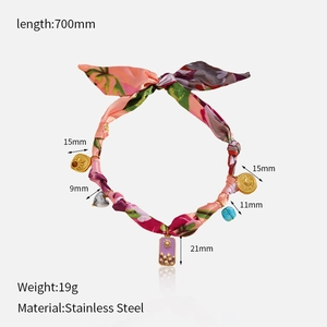Close-up of bohemian fabric scarf necklace featuring stainless steel solar charms