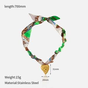 Detail showing the dimensions of the golden heart pendant on a silk scarf necklace