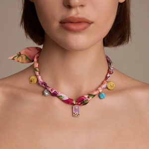 Bohemian silk scarf necklace with floral pendants and vintage coins on a female model