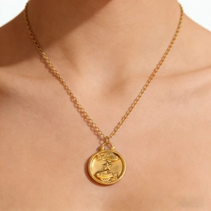 Gold-plated stainless steel Pisces zodiac pendant necklace worn on a model neck