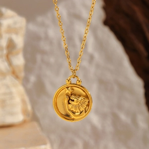 Detailed macro view of the gold Leo zodiac coin pendant necklace on a wooden base