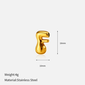Macro view of a 3D bubble style golden letter F pendant made of stainless steel