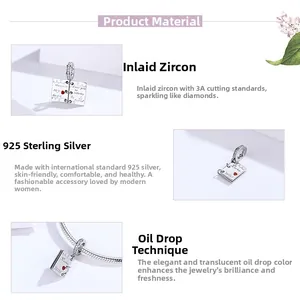 Macro detail of S925 sterling silver love letter charm with red heart and zircon stones