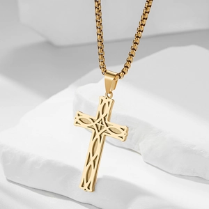 Macro detail of golden Celtic cross pendant with intricate knotted texture on stone