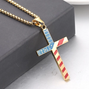 Macro shot of 304 stainless steel gold cross pendant with American flag enamel details