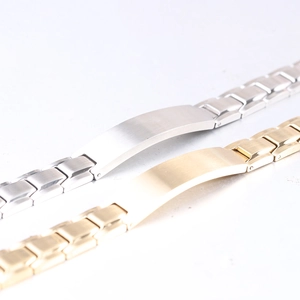 Detail of 12mm brushed stainless steel two-tone bracelets with engravable curved plates