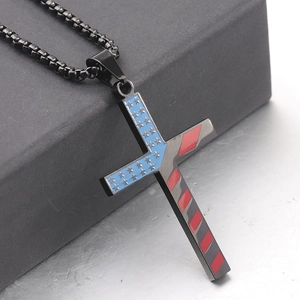 Detail of a black 304 stainless steel cross pendant featuring American flag enamel patterns