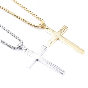 Detail of 50mm sunburst cross pendants in gold and silver steel with box chains