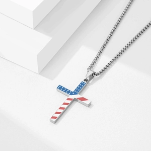 Detail shot of a stainless steel cross pendant featuring American flag stars and stripes pattern
