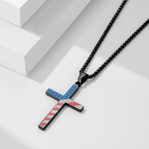 Close-up of black 304 stainless steel cross pendant with American flag pattern detail
