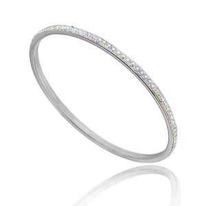 Macro detail of silver stainless steel bangle with rainbow pavé rhinestones and reflection