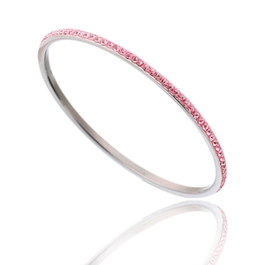 Detail view of a slim silver stainless steel bangle with pink crystal pavé setting