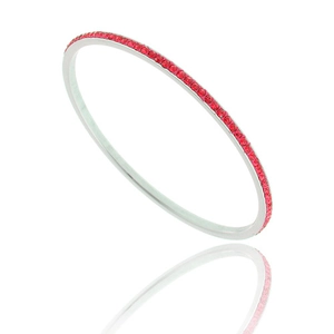 Macro detail of silver stainless steel bangle with row of red zircon crystal stones