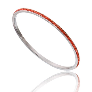 Detail of a slim silver stainless steel bangle with orange rhinestones on white base