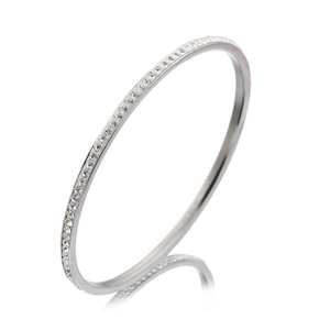 Elegant stainless steel bangle with row of sparkling rhinestones on a white background