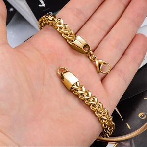 Close-up of a 6mm gold-plated stainless steel wheat link bracelet with a lobster clasp