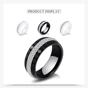 Detailed view of black and white ceramic rings with double-row crystal rhinestones
