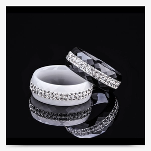 Detail of 8mm faceted black and white ceramic rings with double rows of sparkling crystals