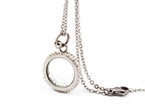 Macro shot of silver titanium steel floating locket necklace with sparkling zircon borders